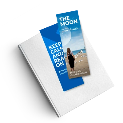 Vibrant full-color 2x6 inch bookmarks laying flat on a white book